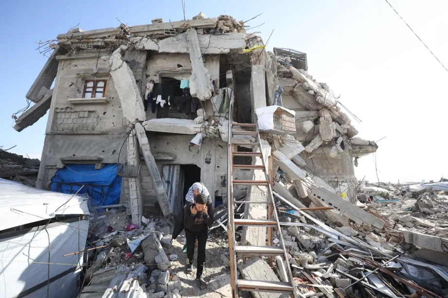 A family member carries 65-year-old Palestinian Haji Nabila Halawa, who lost one leg and was seriously injured in the other after the Israeli attack on her home, as she is unable to move on her own in Gaza City, Gaza on January 12, 2026.