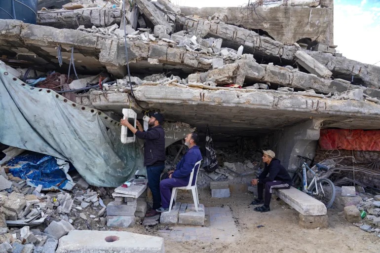 Bassem al-Ghafari, a barber and father of three living in the Sheikh Radwan neighborhood in northern Gaza City, continues to practice his profession, despite his home and barbershop having been destroyed in Israeli attacks, in Gaza City, Gaza