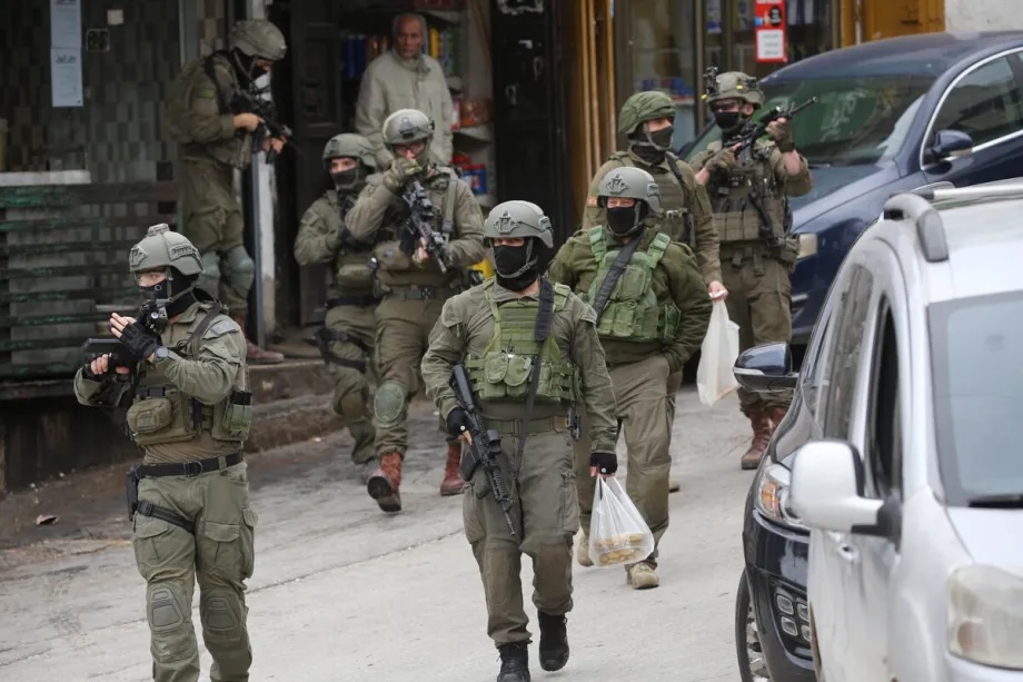 Israeli military forces launch a raid as reinforcement units patrol streets and establish checkpoints throughout the area in Nablus, West Bank on January 22, 2026.