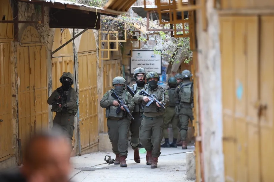 Israeli soldiers take security measures by closing off entry and exit points during raid by Jewish settlers, under the protection of Israeli forces, in Old City area of Hebron, West Bank on January 24, 2026.