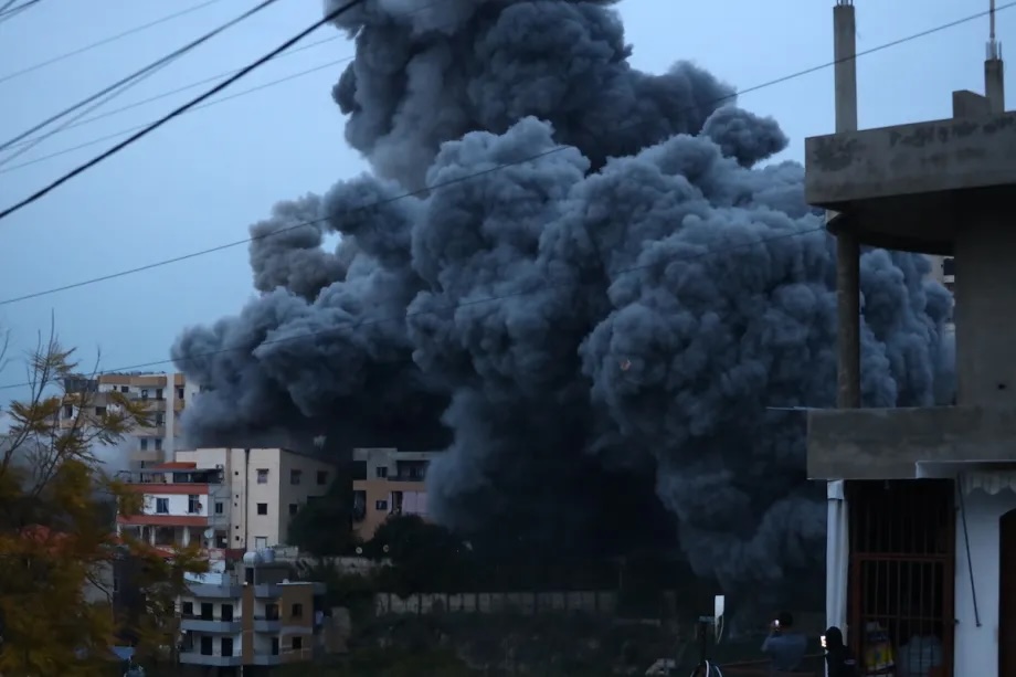 Thick smoke rises from buildings after Israeli airstrikes targeted several locations in the town of Qanarit, south of the city of Sidon, despite an existing ceasefire, on January 21, 2026.