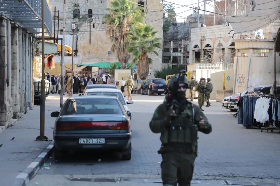 Israeli soldiers block roads and restrict Palestinian movement as illegal Israeli settlers, under the protection of Israeli forces, carry out a raid in the Old City of Hebron in the southern West Bank on December 20, 2025.