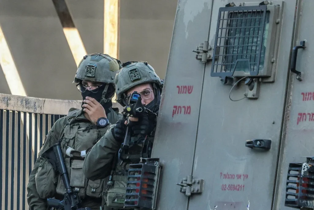 Israeli soldiers take position during a military operation around the old city of the northern West Bank city of Nablus on Sunday.Credit: Jaafar Ashtiyeh/AFP