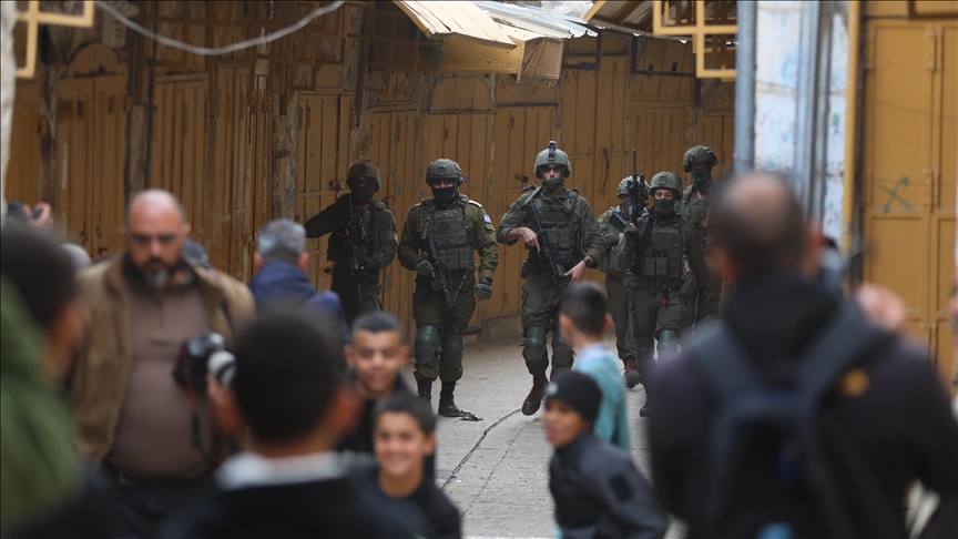 Israeli soldiers take security measures during a raid in the Old City of Hebron, in the southern West Bank on February 14, 2026.