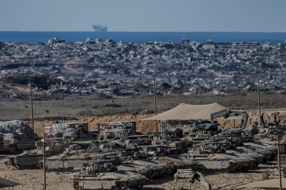 Israeli tanks and military vehicles are seen deployed with some military vehicles, helicopters, and drones patrolling along the border region following the implementation of the ceasefire between Israel and Hamas in Gaza and the withdrawal of Israeli forces inside the yellow line in Sderot, Israel on October 14, 2025.