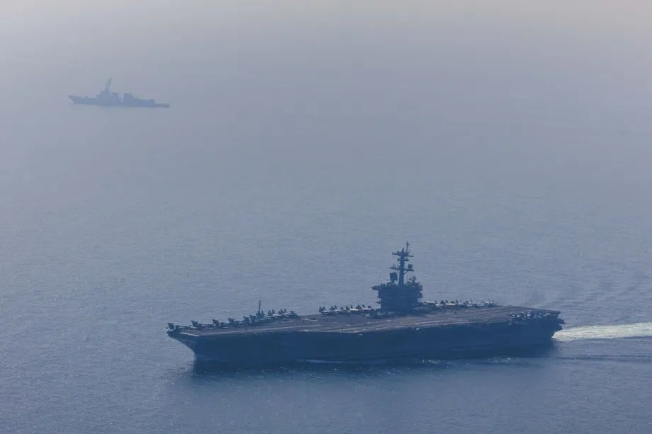 The USS Abraham Lincoln Carrier Strike Group operating in the Arabian Sea, escorted by two military replenishment ships and two U.S. Coast Guard vessels, as fighter jets from Carrier Air Wing Nine conduct flight operations overhead in the Arabian Sea, on February 6, 2026.