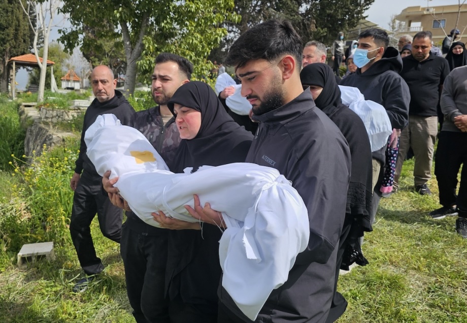 People gather at the town cemetery during the burial of victims killed in an Israeli airstrike in Sidon, southern Lebanon on March 13, 2026.