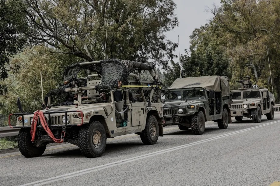 Israeli military vehicles and tanks are stationed near the Lebanese border in northern Israel on March 14, 2026.