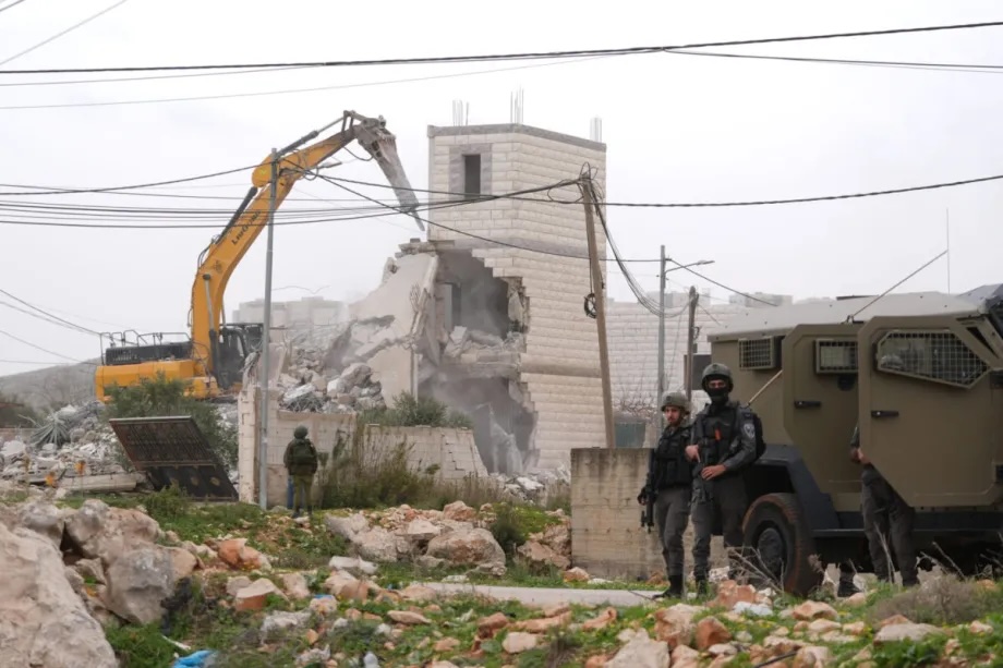 Israeli forces demolish a two-storey Palestinian-owned building, claiming it lacked a permit, during a military raid in the city of Nablus, located in the West Bank on February 17, 2026.