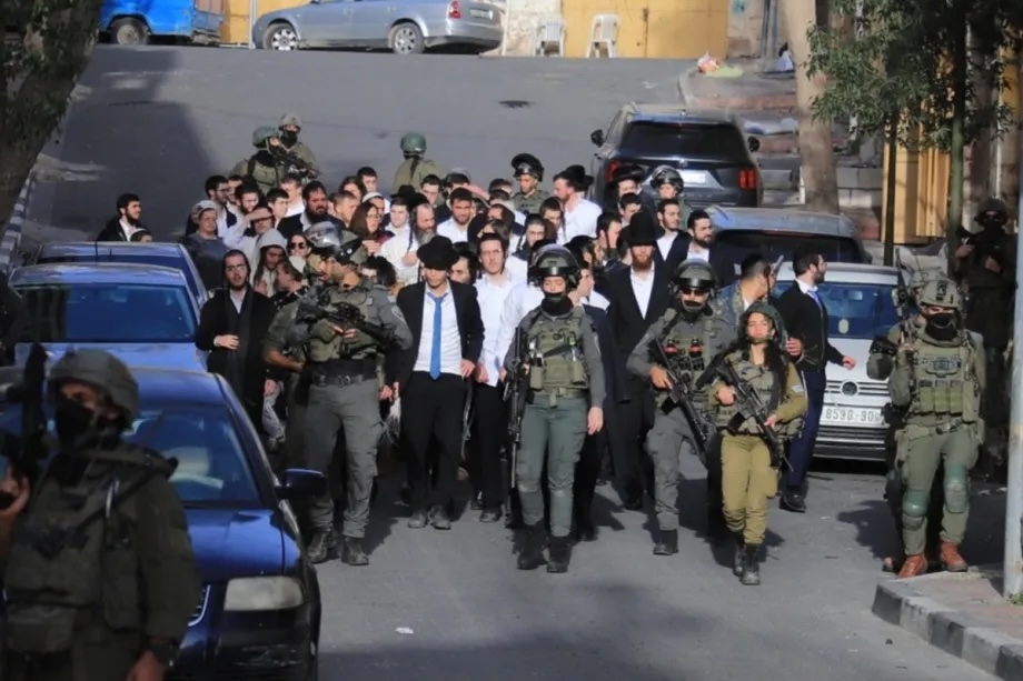 Israeli settlers, under the protection of Israeli forces, raid the Old City of Hebron in the southern West Bank on January 31, 2026.