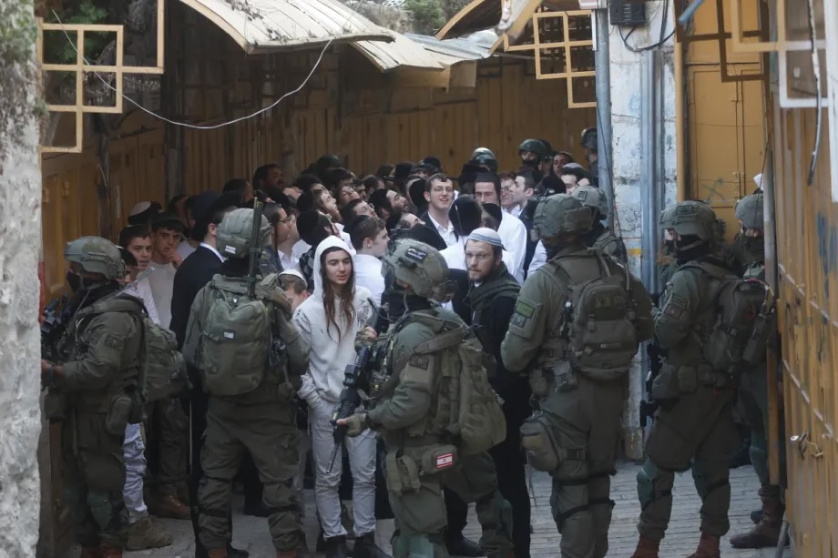 Israeli settlers, under the protection of Israeli forces, raid the Old City of Hebron in the southern West Bank on January 31, 2026.