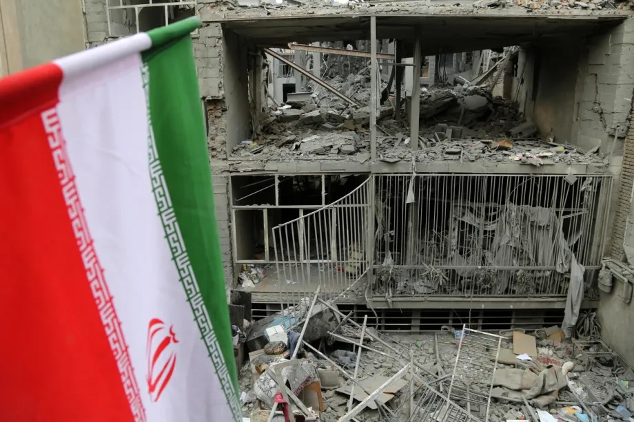 A view of Iranian flag with major destruction at Javadiyeh and Beryanak districts as a result of US-Israeli attacks in Tehran, Iran on March 15, 2026.