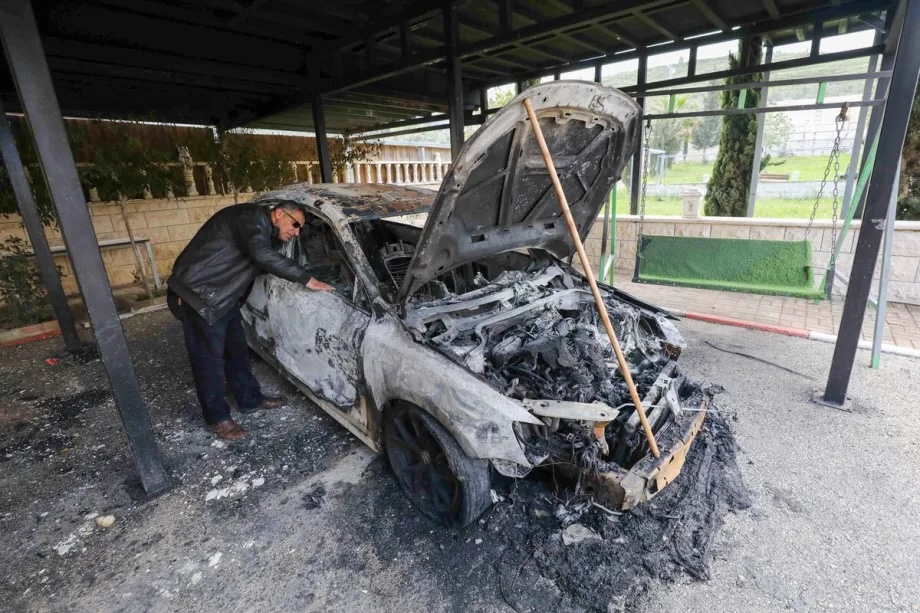 A Palestinian inspects his burned vehicle after Israeli settlers set fire to cars and spray racist slogans on walls in the town of Silat al-Zahr in Jenin province, West Bank, on March 22, 2026. 

