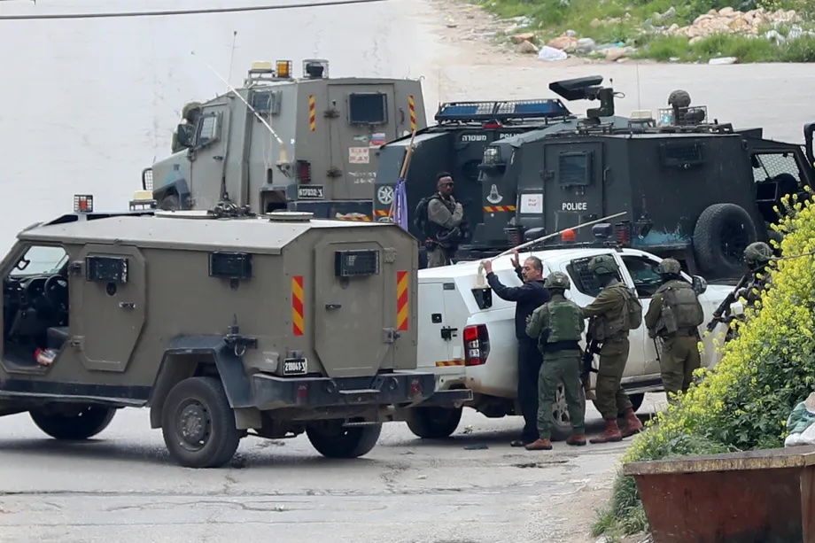 Israeli forces detain a Palestinian during a raid on the West Bank city of Hebron, Palestine, on March 24, 2026.