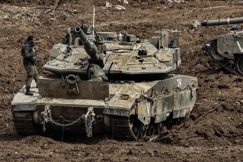 Israeli military vehicles and tanks are stationed near the Lebanese border in northern Israel on March 14, 2026.