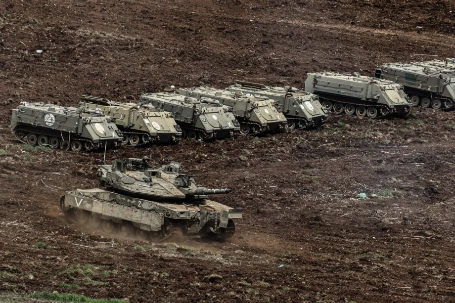 Israeli military vehicles and tanks are stationed near the Lebanese border in northern Israel on March 14, 2026.