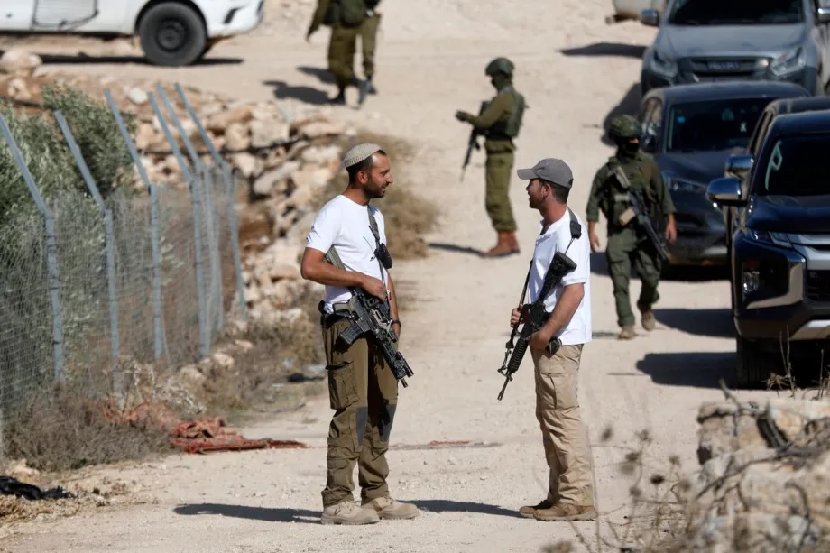 Israeli forces and Israeli settlers prevent Palestinian farmers from working on their agricultural fields in the town of Beit Ulla, located west of the city of Hebron, West Bank on November 22, 2025.