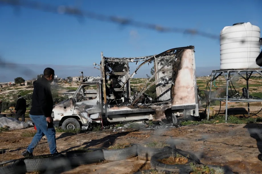 A man takes a look at a damaged car as the town of Susiya sustained heavy damage following an attack by Israelis in the Hebron governorate of the West Bank, on February 25, 2026.