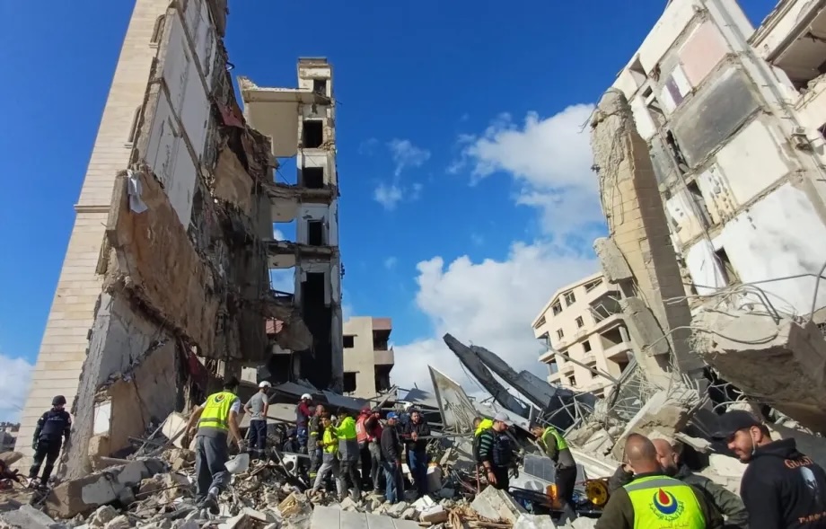 Emergency teams and residents inspect the damage at the site of a building hit during an Israeli strike in Sidon, southern Lebanon on April 8, 2026.