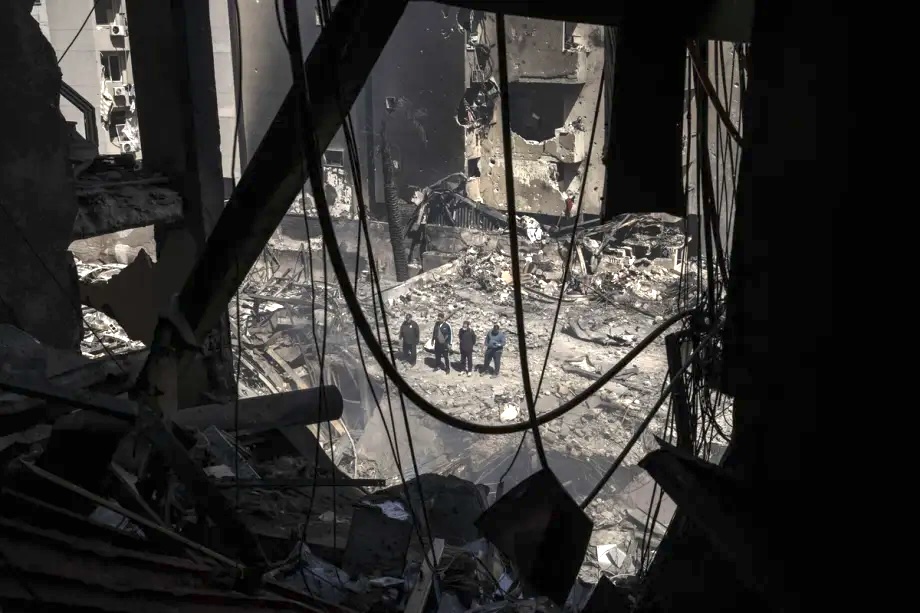 Civilians inspect the site as a residential building lies in ruins and surrounding structures show heavy damage after an Israeli strike hits Corniche Al-Mazraa district in Beirut, Lebanon on April 09, 2026.