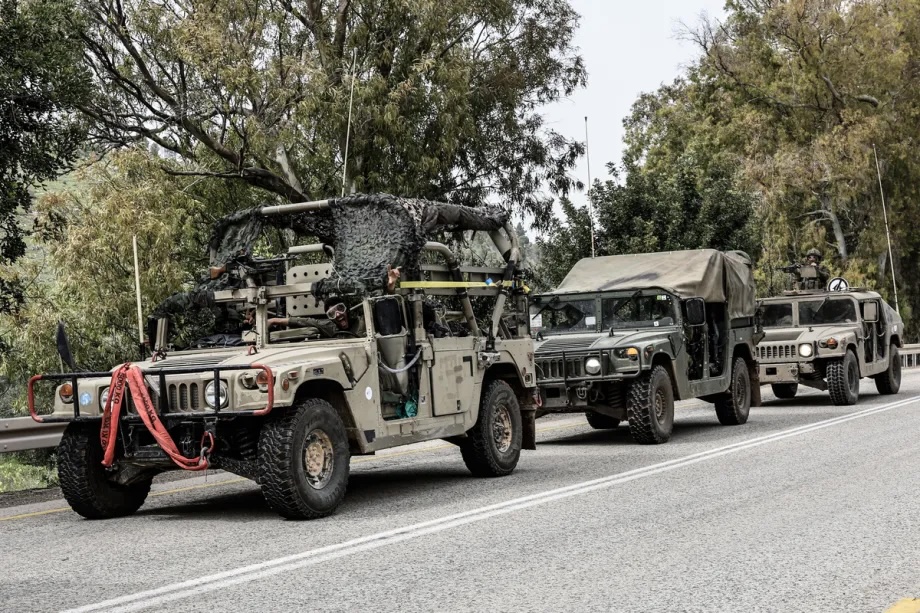 Israeli military vehicles and tanks are stationed near the Lebanese border in northern Israel on March 14, 2026.
