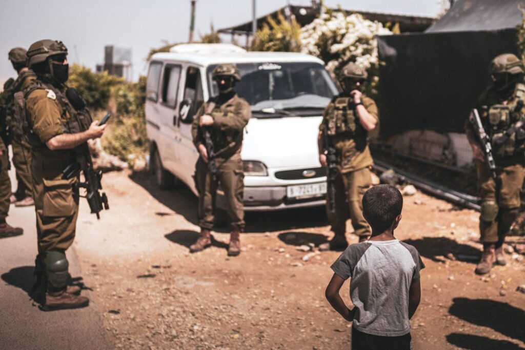 Israeli forces outside the mourning tent for Awdah Hathaleen
in the village of Umm al-Khair, West Bank