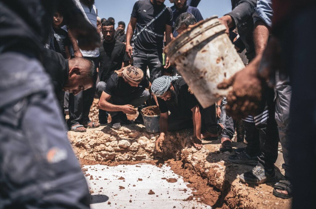 Group of men creating a funeral plot.