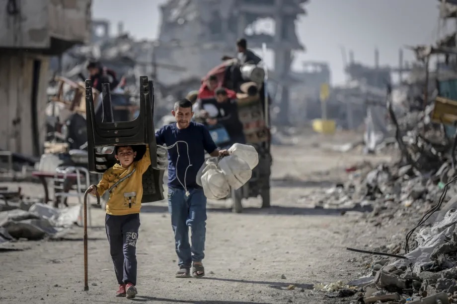 Palestinian families set out for a new place to stay, taking with them whatever belongings they could carry, in Gaza Strip on November 21, 2025. 

