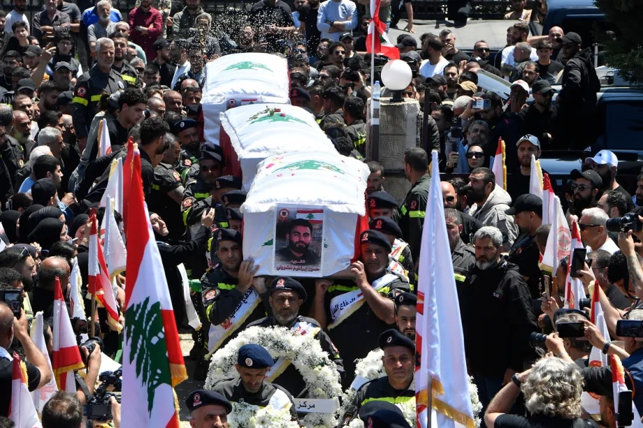 People attend a funeral for three civil defense members killed in the town of Majdal Zoun in an Israeli strike, on April 30, 2026. 