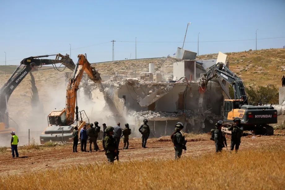 Israeli forces demolish a two-story Palestinian house in the village of Ed-Deirat, part of the town of Yatta in the southern West Bank, while taking security measures in the area on May 4, 2026, in Hebron, West Bank, Palestine.