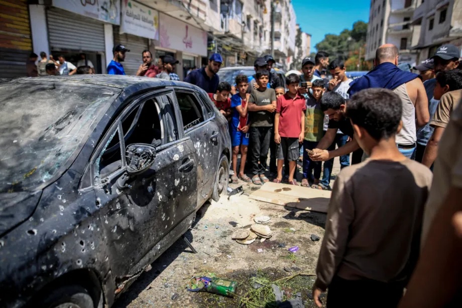 Palestinians inspect the damaged car after Israeli unmanned aerial vehicles (UAVs) targeted civilian vehicles in the Rimal neighborhood of Gaza City, Gaza, Palestine on June 22, 2026.
