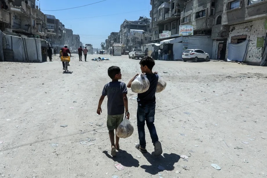 Displaced Palestinians gather to receive bread distributed by the World Food Programme (WFP) in Khan Yunis, Gaza, Palestine on June 19, 2026.