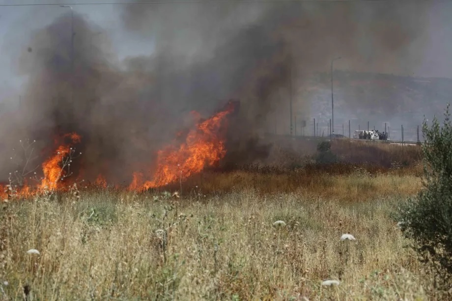 Palestinians attempt to extinguish the fire using their own means after Israeli settlers set fire to agricultural fields belonging to Palestinians in the town of Huwara, near Nablus, West Bank, Palestine on June 06, 2026.