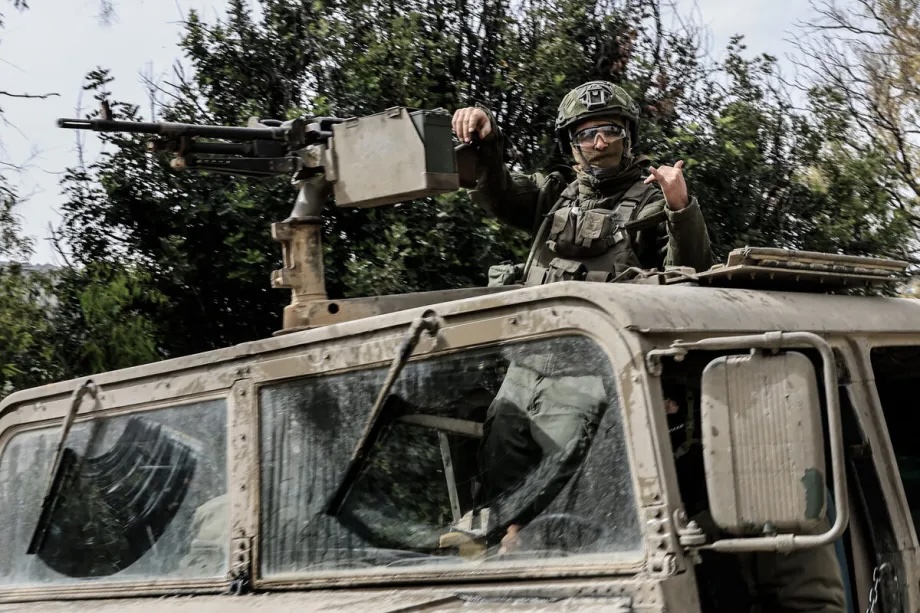 Israeli military vehicles and tanks are stationed near the Lebanese border in northern Israel on March 14, 2026.