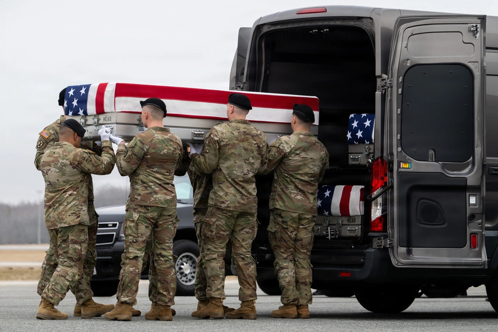 A US Army carry team transfers the remains of Army Sgt. Declan J. Coady, 20, of West Des Moines, Iowa, who was killed in the Iran war, March 7, 2026, at Dover Air Force Base, Delaware