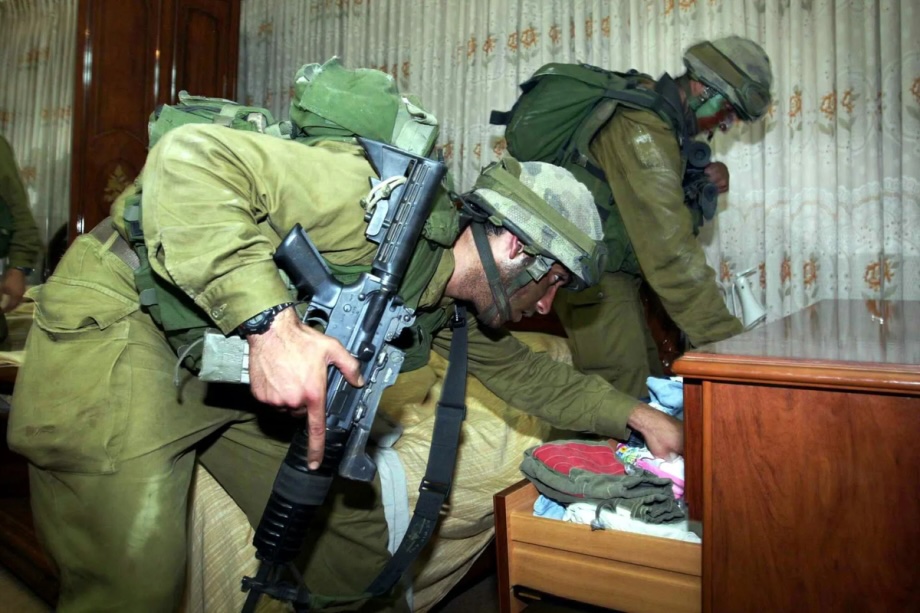 Israeli soldiers conduct a search inside a Palestinian home in the West Bank

