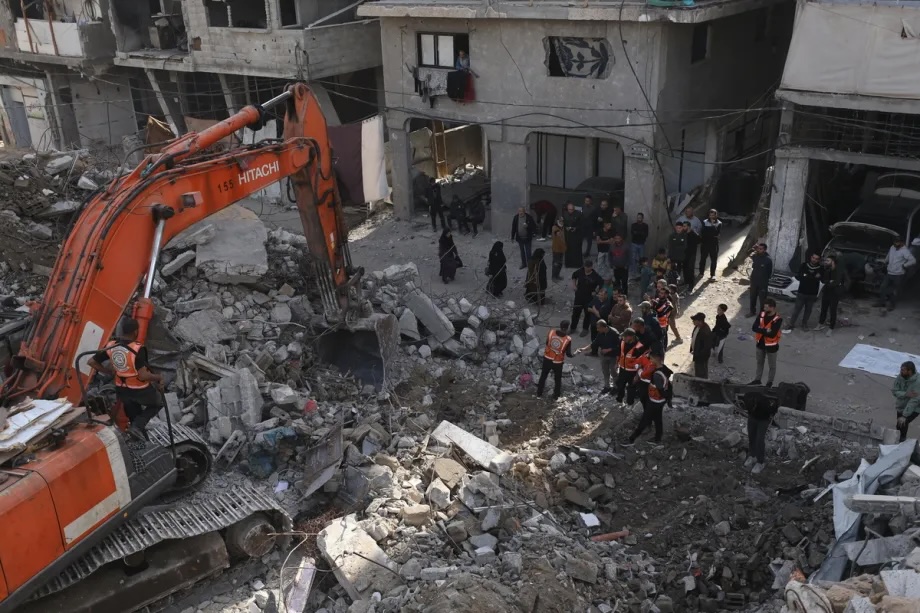 Palestinian civil defense teams carry out search and recovery operations with heavy machinery at the site of a building destroyed during Israeli attacks in the Sheikh Radwan neighborhood of Gaza City, on February 12, 2026.