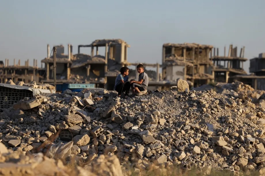 Residents try to continue their lives in tents erected on the rubble of destroyed buildings and inside damaged structures as traces of war remain in the town of Ayn Terma in the Damascus countryside, Syria, on July 30, 2026.