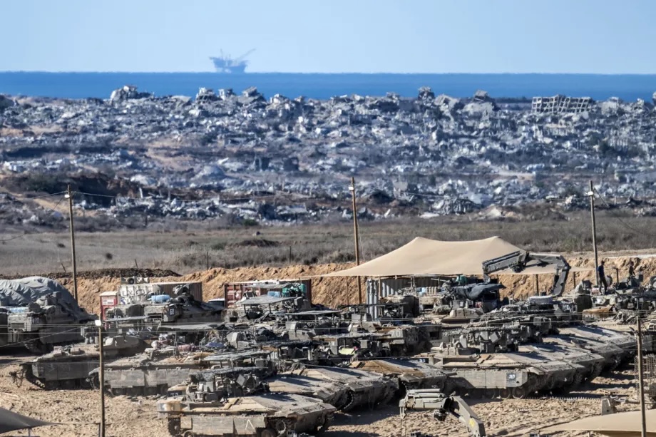 Israeli tanks and military vehicles are seen deployed with some military vehicles, helicopters, and drones patrolling along the border region following the implementation of the ceasefire between Israel and Hamas in Gaza and the withdrawal of Israeli forces inside the yellow line in Sderot, Israel on October 14, 2025.