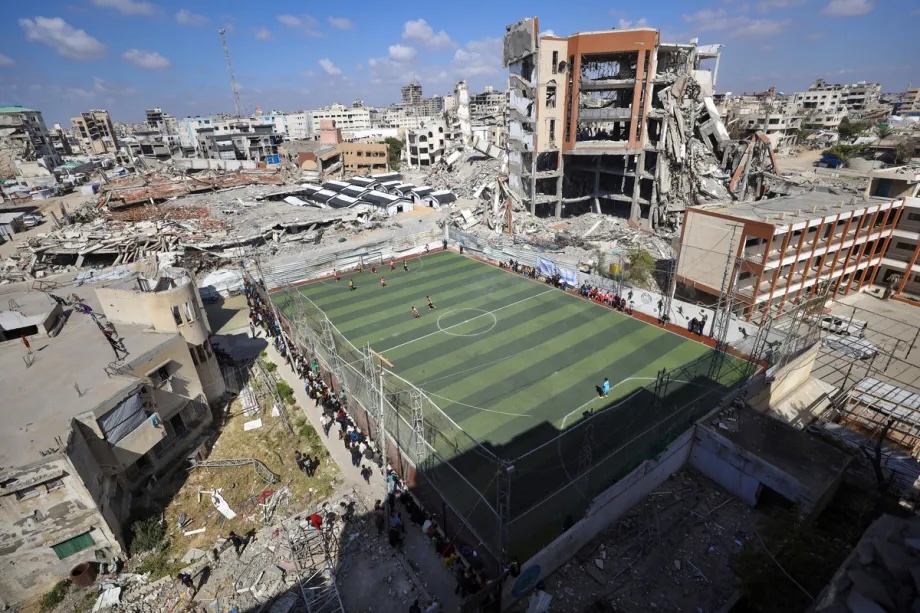 Players of under-18 of Gaza Sports Club and Jabalia Services Sports Club take part in the football match in a 5v5 format at Palestine Stadium, which lies amidst the rubble of buildings destroyed by the strikes, to revive the spirit of sports in Gaza City, Gaza, Palestine on April 20, 2026.